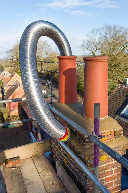 Hales Chimney-Stock image of Chimney Liner Steel liner being replaced in chimney