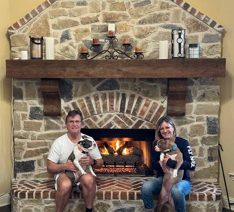 Orginal Photo- About Us- Hales Chimney man and woman holding dogs and sitting by fireplace