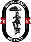 Member National Chimney Sweep Guild climbing on chimney with umbrella and brush
